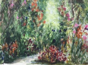 Profusion of colourful plants, next to a path through the flower beds. Evokes the balmy heat of summer